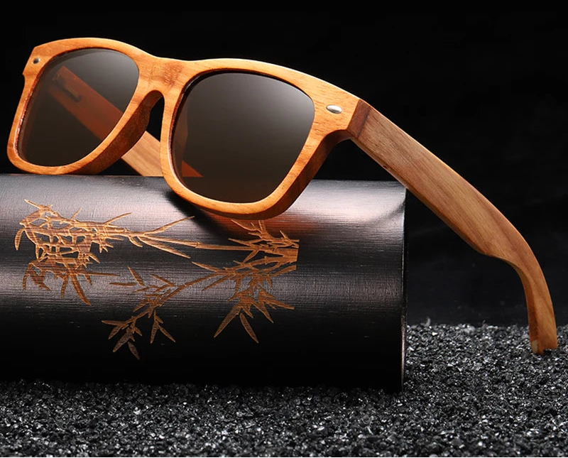 Wooden sunglasses with dark lenses on a black background, featuring the brand 'GM Eyewear'.