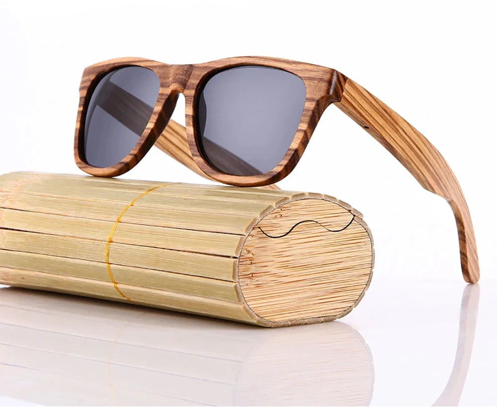 Wooden sunglasses with a bamboo case on a white background, featuring the brand 'GM Eyewear'.